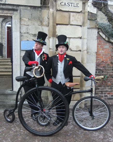 dickensian entertainers with penny farthings