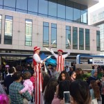 red & white striped stilt walkers
