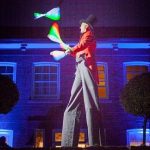 stilt walking glow juggler performing at wedding