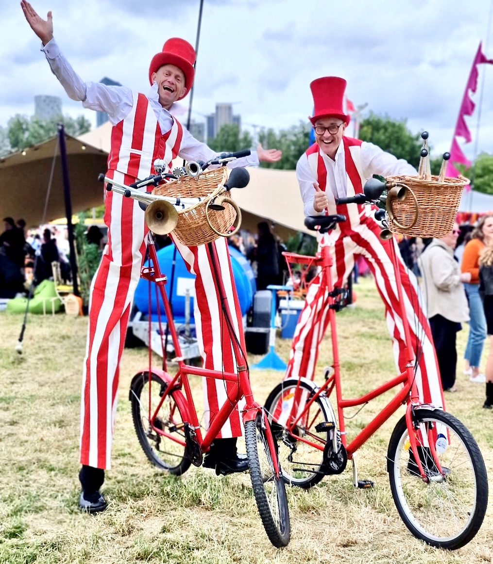stilt walkers on bikes